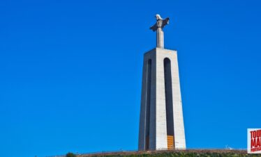 Towering Cristo Rei statue overlooking Lisbon, part of a tour by Tour Map Portugal
