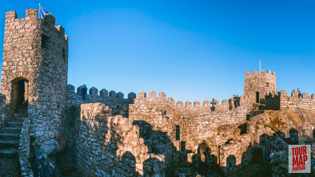 Historic walls and towers of the Moorish Castle in Sintra. Built in the 8th century, this ancient fortress stands as a testament to Sintra’s rich history. Its rugged walls and towers provide breathtaking views over Sintra and the surrounding forests, blending natural beauty with historical significance with Tour Map Portugal.