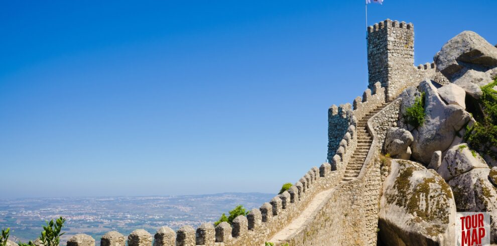 Historic walls and towers of the Moorish Castle in Sintra. Built in the 8th century, this ancient fortress stands as a testament to Sintra’s rich history. Its rugged walls and towers provide breathtaking views over Sintra and the surrounding forests, blending natural beauty with historical significance with Tour Map Portugal.