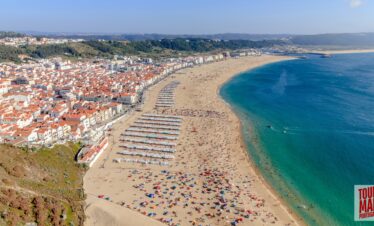 Coastal town of Nazaré, Portugal, known for giant waves and beach views with Tour Map Portugal.