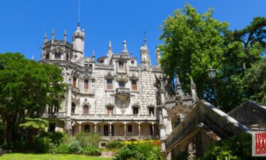 Gothic architecture and lush gardens of Quinta da Regaleira. Known for its elaborate Gothic-style architecture and enigmatic gardens, this UNESCO site is filled with hidden tunnels, lakes, and the iconic Initiation Well, offering an otherworldly experience steeped in symbolism and mystery with Tour Map Portugal.
