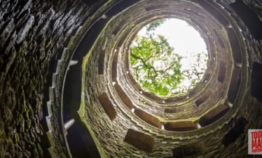 Gothic architecture and lush gardens of Quinta da Regaleira. Known for its elaborate Gothic-style architecture and enigmatic gardens, this UNESCO site is filled with hidden tunnels, lakes, and the iconic Initiation Well, offering an otherworldly experience steeped in symbolism and mystery.