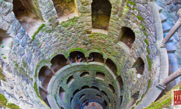 Gothic architecture and lush gardens of Quinta da Regaleira. Known for its elaborate Gothic-style architecture and enigmatic gardens, this UNESCO site is filled with hidden tunnels, lakes, and the iconic Initiation Well, offering an otherworldly experience steeped in symbolism and mystery.