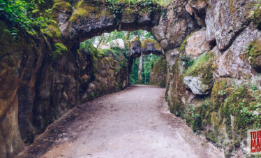 Gothic architecture and lush gardens of Quinta da Regaleira. Known for its elaborate Gothic-style architecture and enigmatic gardens, this UNESCO site is filled with hidden tunnels, lakes, and the iconic Initiation Well, offering an otherworldly experience steeped in symbolism and mystery.
